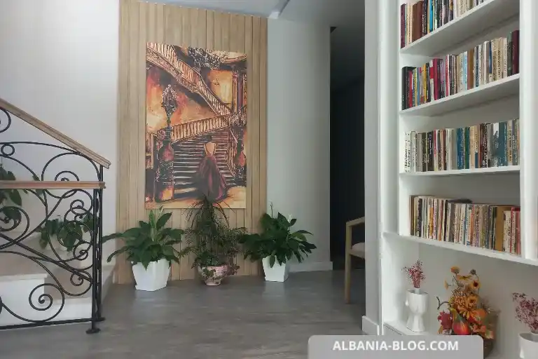 Sea Side hotel interior lobby in Vlore featuring reception area, marble staircase, bookshelves and a large decorative wall painting