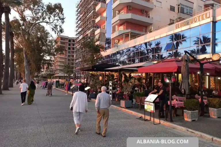Lungomare promenade in Vlore with people walking and busy El Mare restaurant near Sea Side hotel