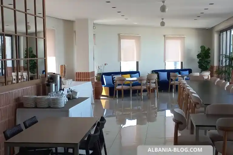 Bright dining area at Valza Boutique Hotel Vlore with large windows and lounge seating