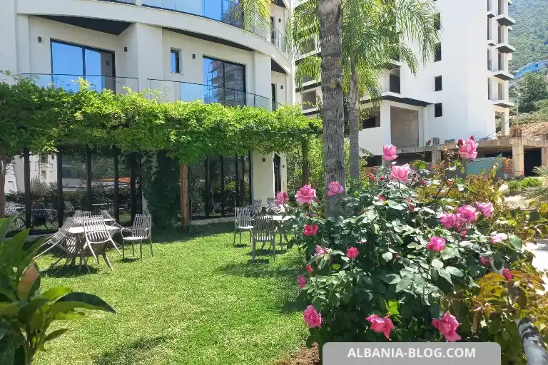 Garden lawn at Valza Boutique Hotel Vlore with seating and flowers