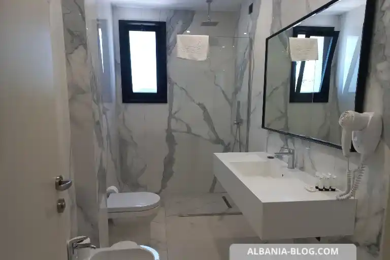 Modern clean bathroom at Valza Boutique Hotel Vlore with shower, mirror, and natural light