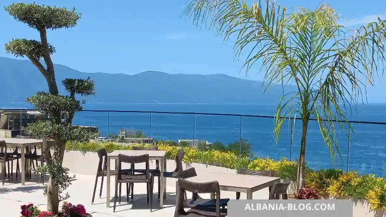 Rooftop terrace view at Valza Boutique Hotel in Vlore overlooking the sea, mountains, and outdoor seating area