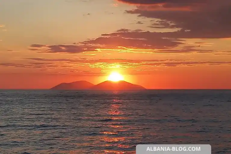 Sunset over Sazan Island with red sky and sea reflections in Vlore