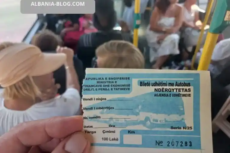 Official 100 ALL bus ticket for Durres Golem route held inside a large bus