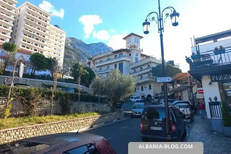 Narrow street in the historic center of Kruja with parked cars