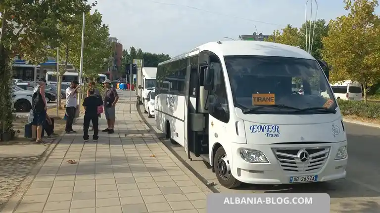 White Mercedes intercity bus with Tirane destination sign parked at Vlore bus terminal near Kastrati